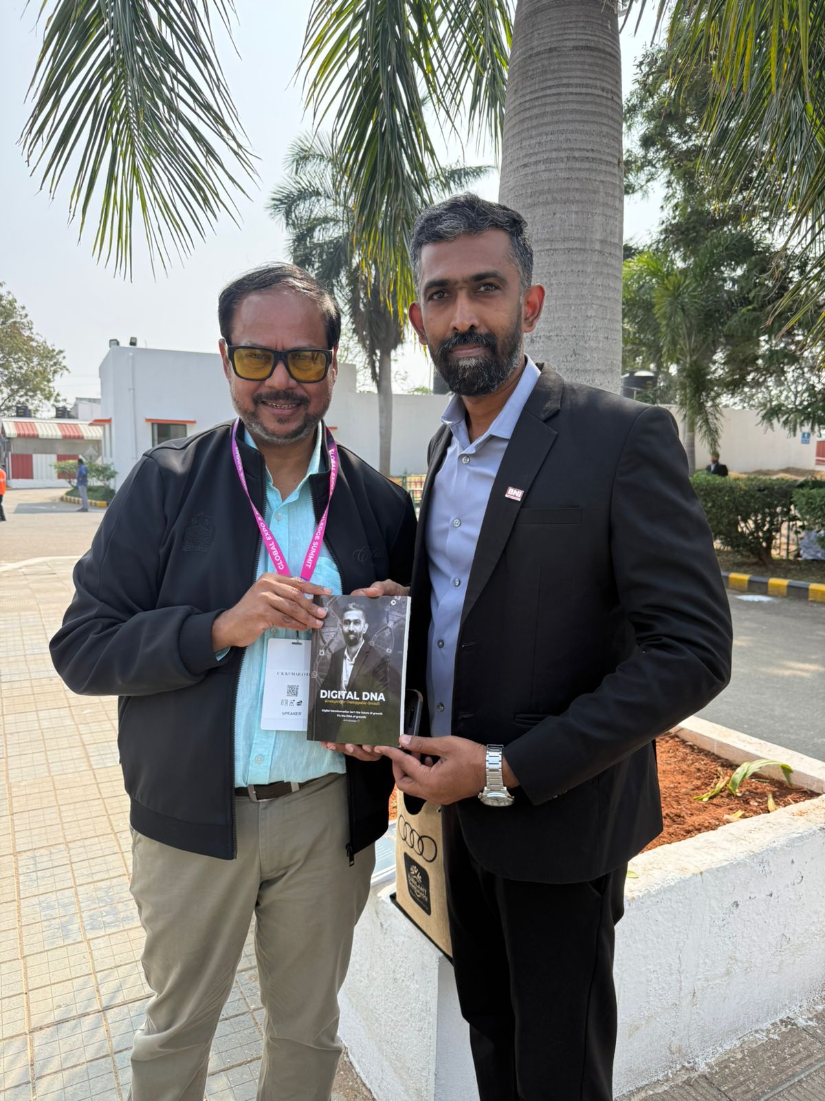 Selvakumar D presenting the Digital DNA book to Naturals MD CK Kumaravel at a business networking event